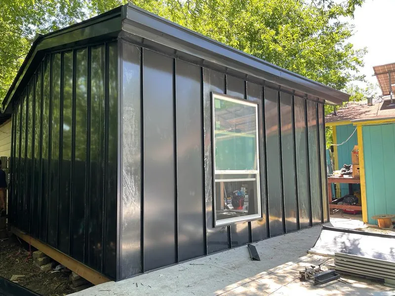 Black standing seam metal wall panels for Roof Inspection in St. Robert