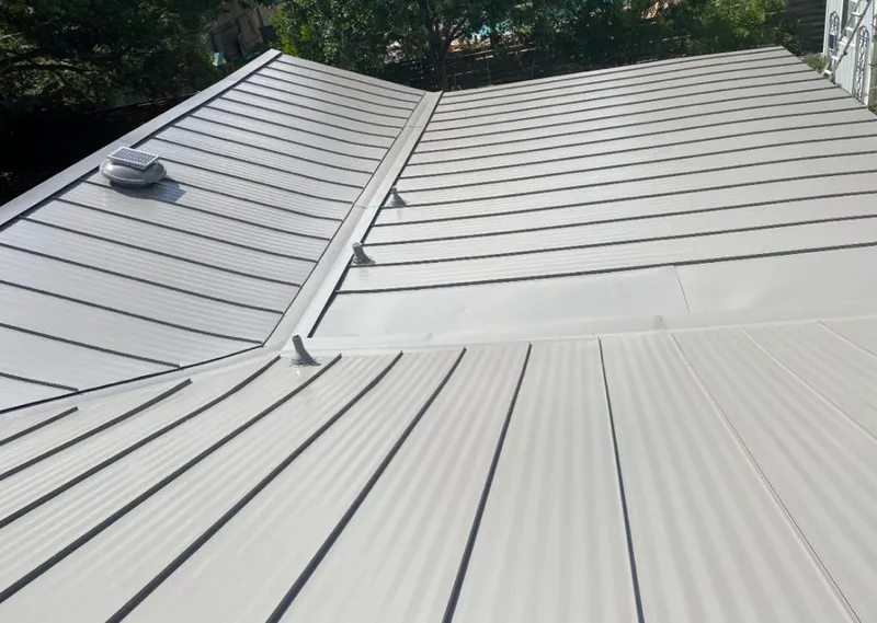 Solar attic fan installed on a metal roof for Roof Ventilation in St. Robert